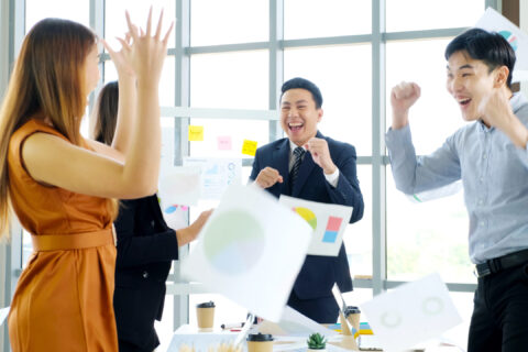 Business success corporate, Asian business team smiling and arms up after success job with partner, Happy teamwork rise hand for achievement together at meeting room office